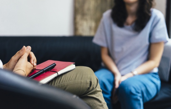 Client meeting with a licensed professional during a counseling session